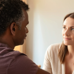 **Prompt 1: The essence of empathetic health coaching**
    "A compassionate health coach, a woman or man, actively listening to a client in a modern, serene wellness office. Soft, natural lighting. The scene conveys deep trust and understanding through the body language of both individuals. The client appears reflective, while the coach offers subtle, supportive gestures, emphasizing empathy, active listening, and genuine human connection in a professional setting. Warm, inviting tones."